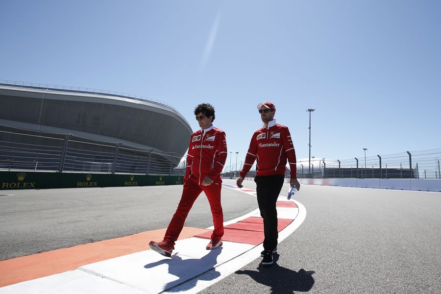 Sebastian Vettel walks the track with Edoardo Brosco