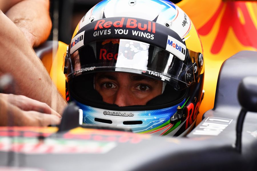 Daniel Ricciardo sits in the Red Bull cockpit in the garage