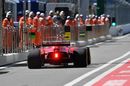 Kimi Raikkonen heads down the pit lane in the Ferrari