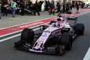 Sergio Perez powers down the pit lane in the Force India