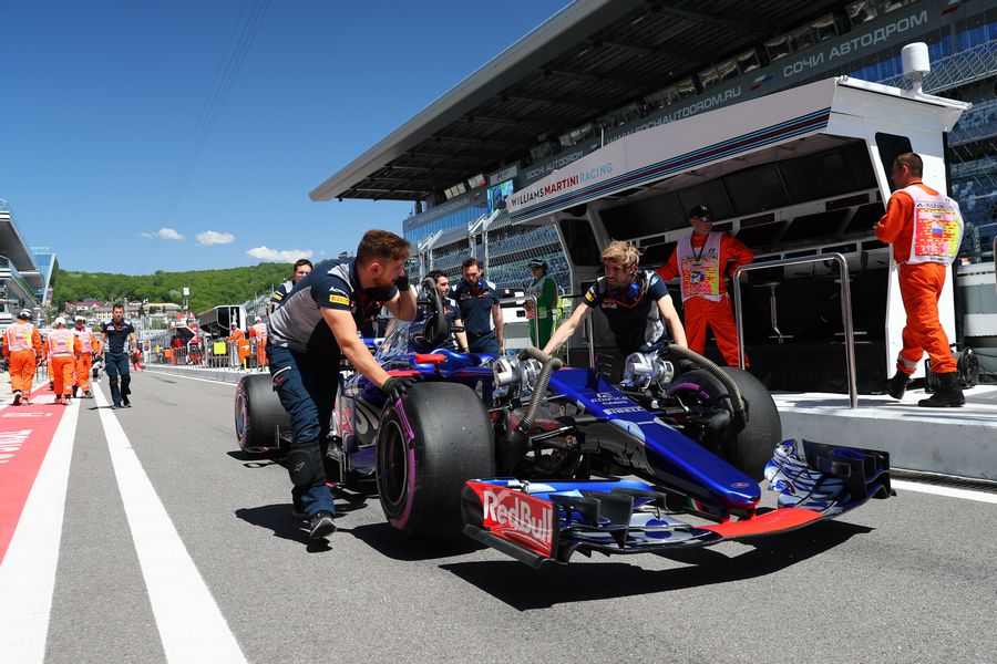 Toro Rosso mechanics push the car of Daniil Kvyat