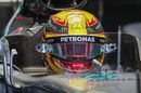 Lewis Hamilton sits in the Mercedes cockpit in the garage