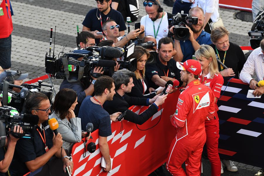 Sebastian Vettel talks with media