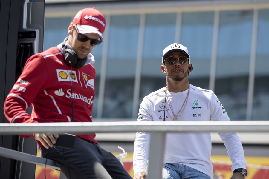 Sebastian Vettel and Lewis Hamilton Palmer enjoy the drivers parade