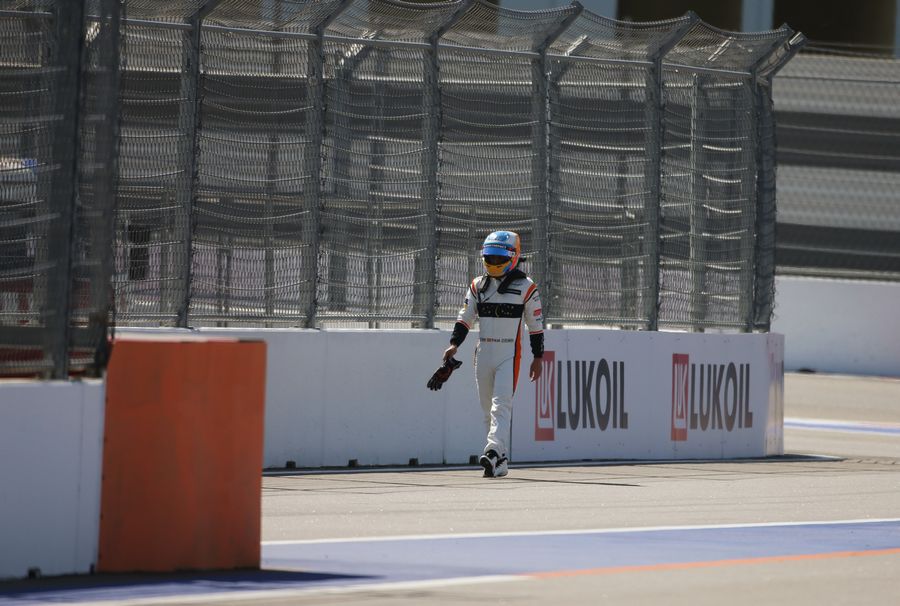 Race retiree Fernando Alonso walks on track
