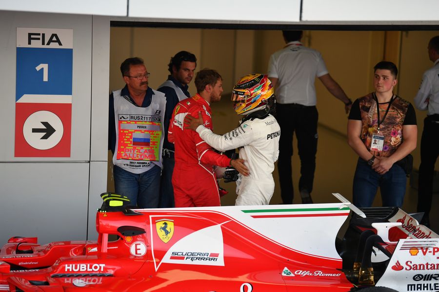 Sebastian Vettel and Lewis Hamilton celebrate in parc ferme