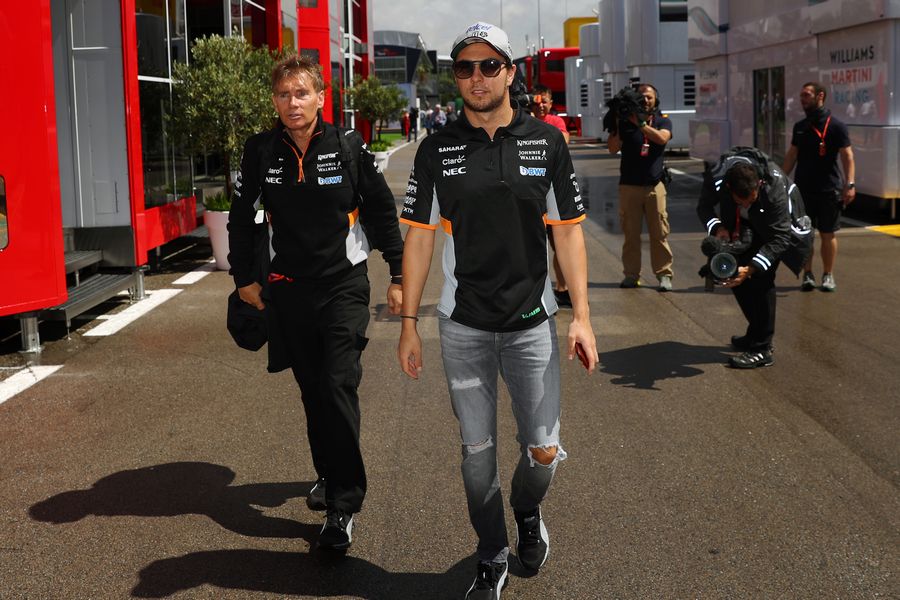 Sergio Perez walks the paddock with his trainer Xavi Martos