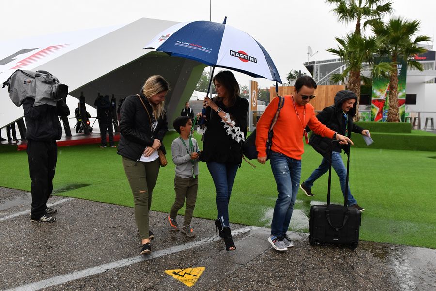 Felipe Massa walks the paddock with his wife Rafaela Bassi and son Felipinho Massa