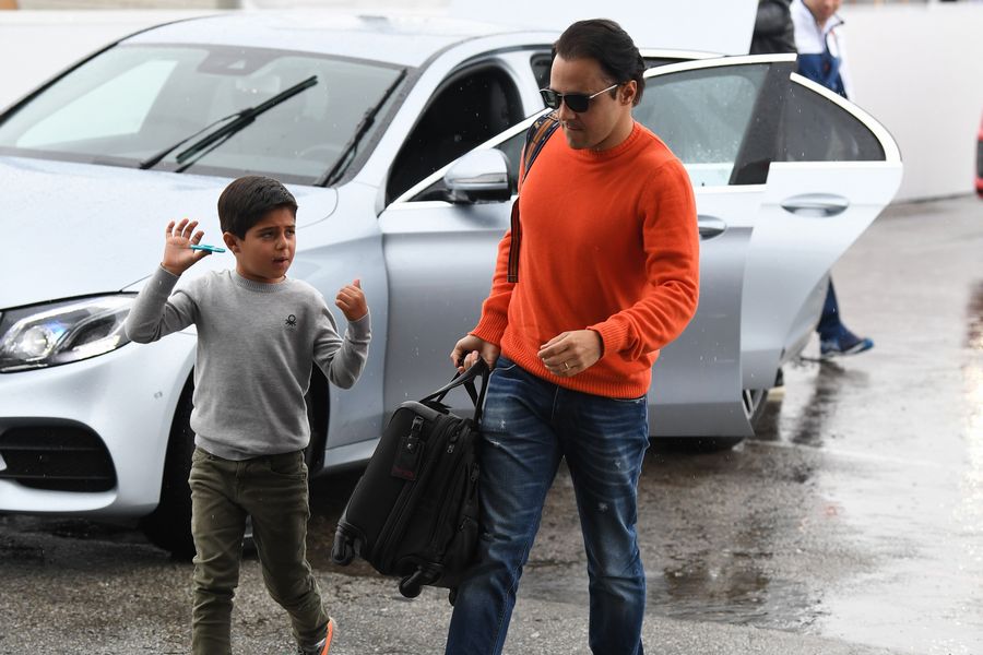 Felipe Massa walks the paddock with his son Felipinho Massa