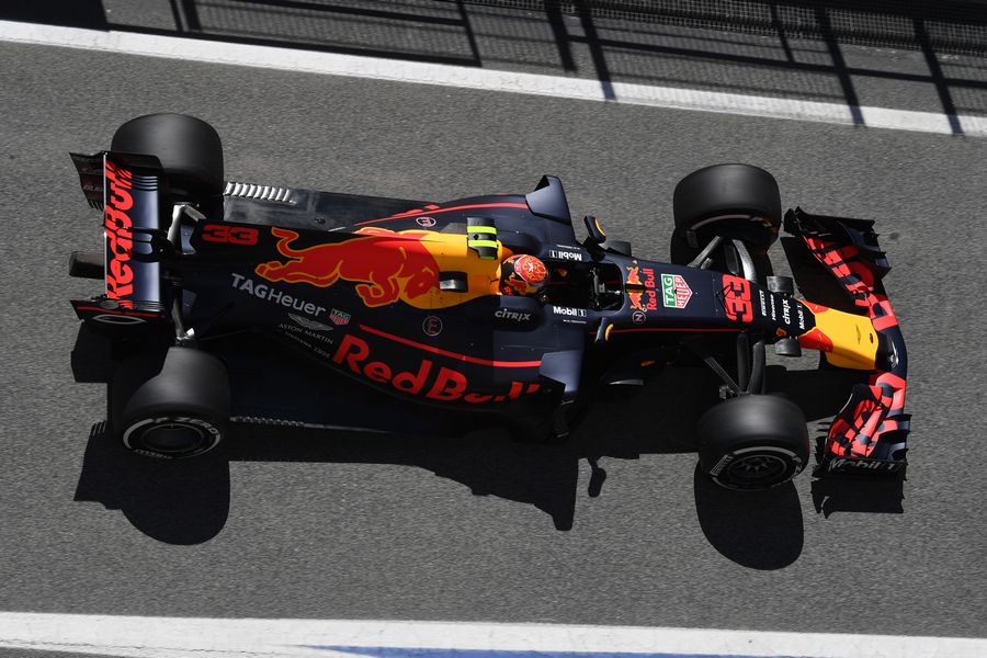 Max Verstappen powers down the pit lane in the Red Bull