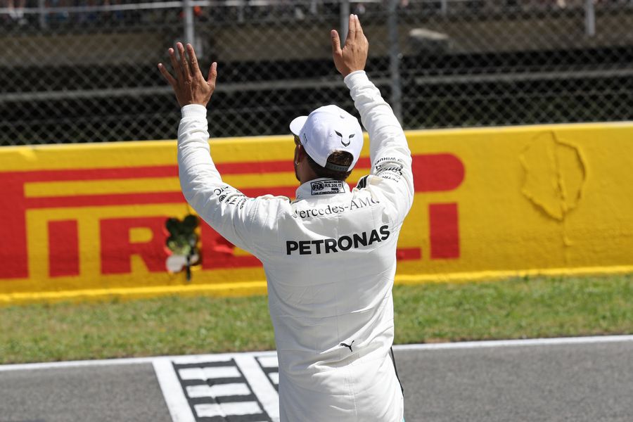 Pole sitter Lewis Hamilton waves to fans