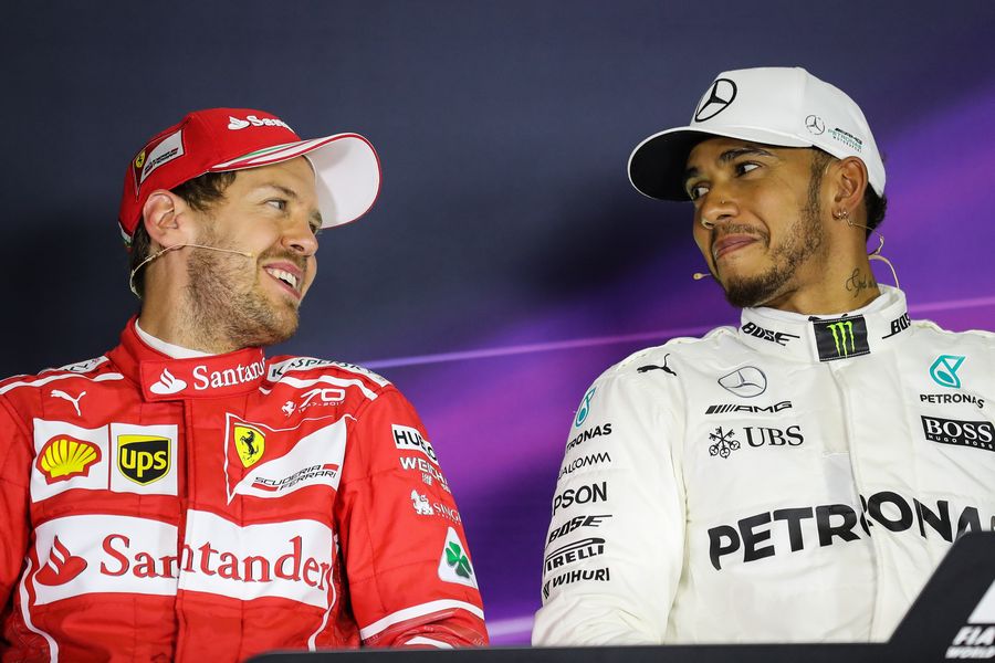 Lewis Hamilton talks with Sebastian Vettel in the press conference
