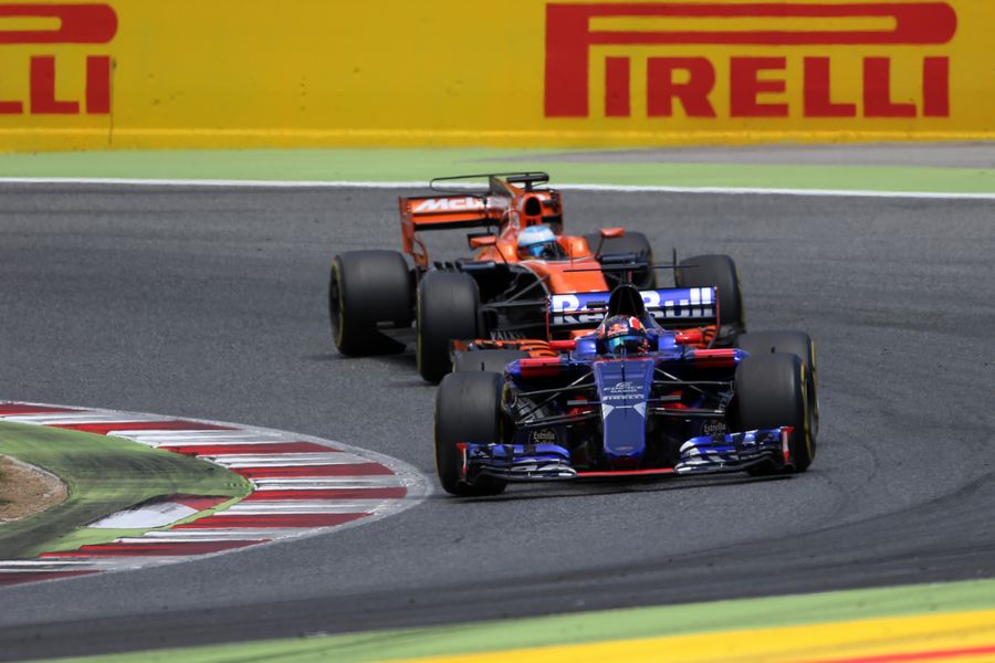 Daniil Kvyat leads Fernando Alonso