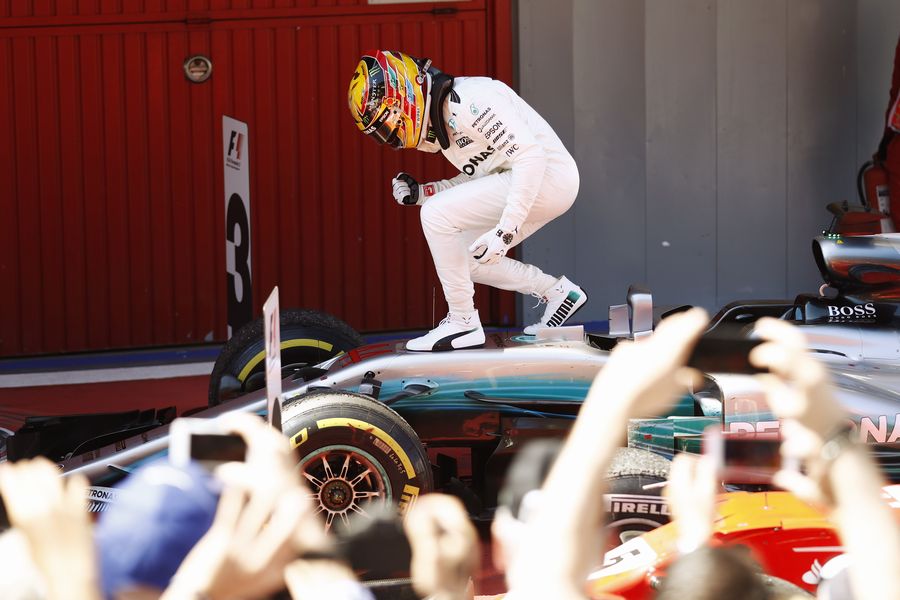 Lewis Hamilton cerebrates on the palc ferme