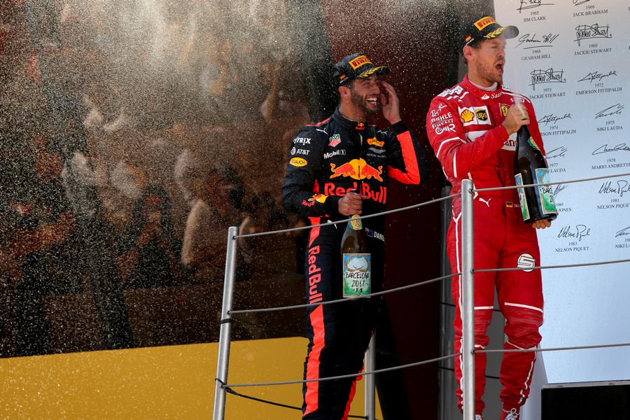 Daniel Ricciardo and Sebastian Vettel celebrate on the podium with the champagne
