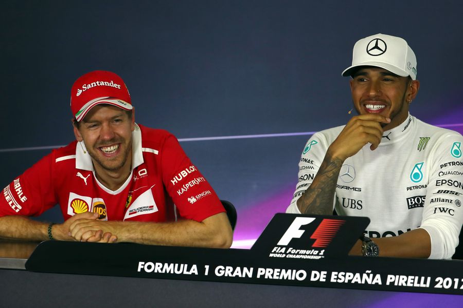 Sebastian Vettel and Lewis Hamilton relaxes in the press conference