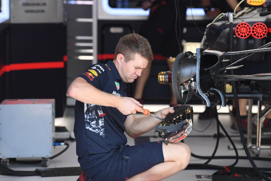 Red Bull Racing mechanic works on RB13 floor