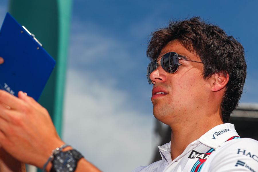 Lance Stroll signs autograph for a fans