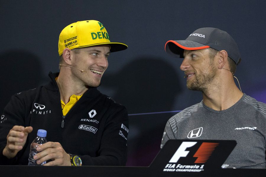Nico Hulkenberg talks with Jenson Button in the Press Conference