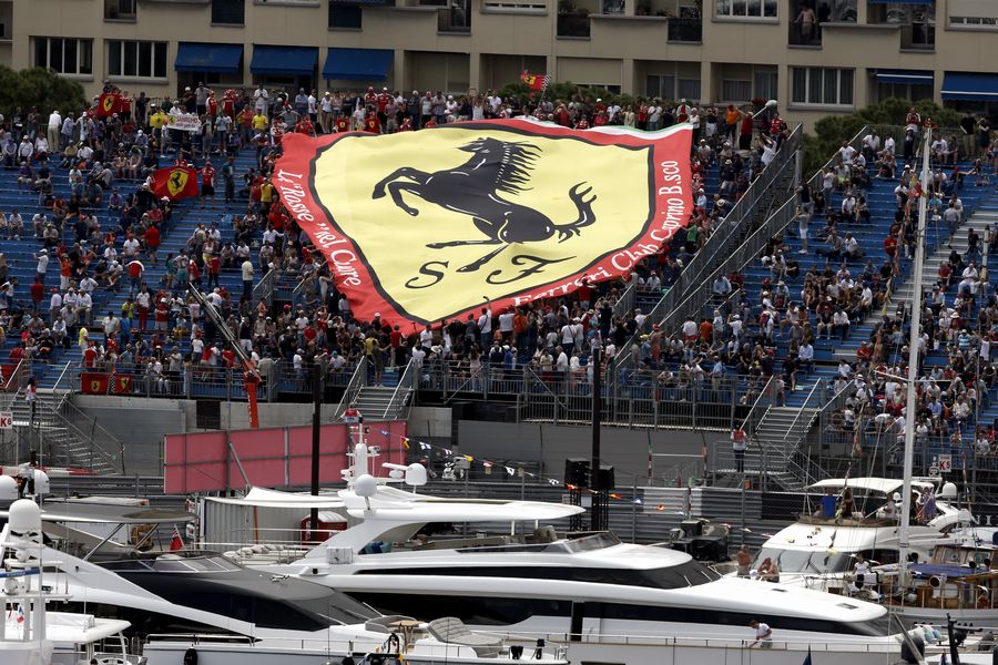 Yachts in the harbour and Fans with Ferrari Flag in the grandstand