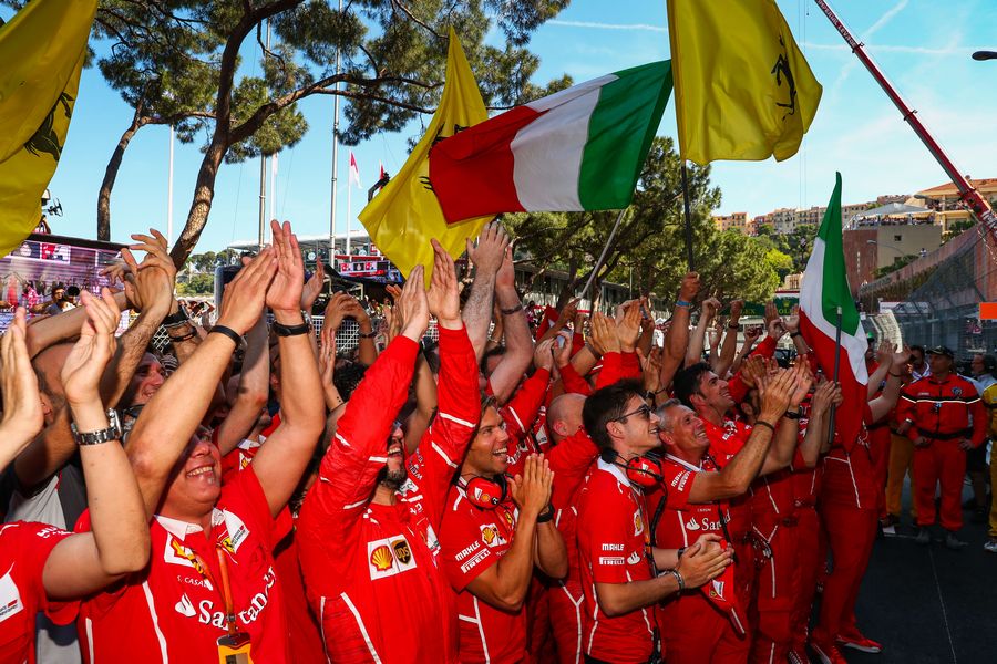 Ferrari team mechanics celebrate in parc ferme