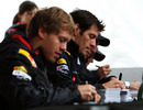 Sebastian Vettel and Mark Webber sign autographs for fans on a rainy Thursday in Montreal
