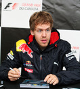 Sebastian Vettel signs autographs for fans on a rainy Thursday in Montreal