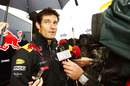 Mark Webber talks to the media in a wet Montreal paddock