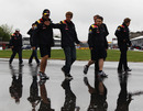 Sebastian Vettel walks a wet Circuit Gilles Villeneuve with his race engineers
