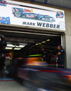 Mark Webber flashes out of the Red Bull pits for free practice 1