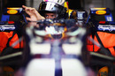 Sebastian Vettel adjusts his mirror in the pits