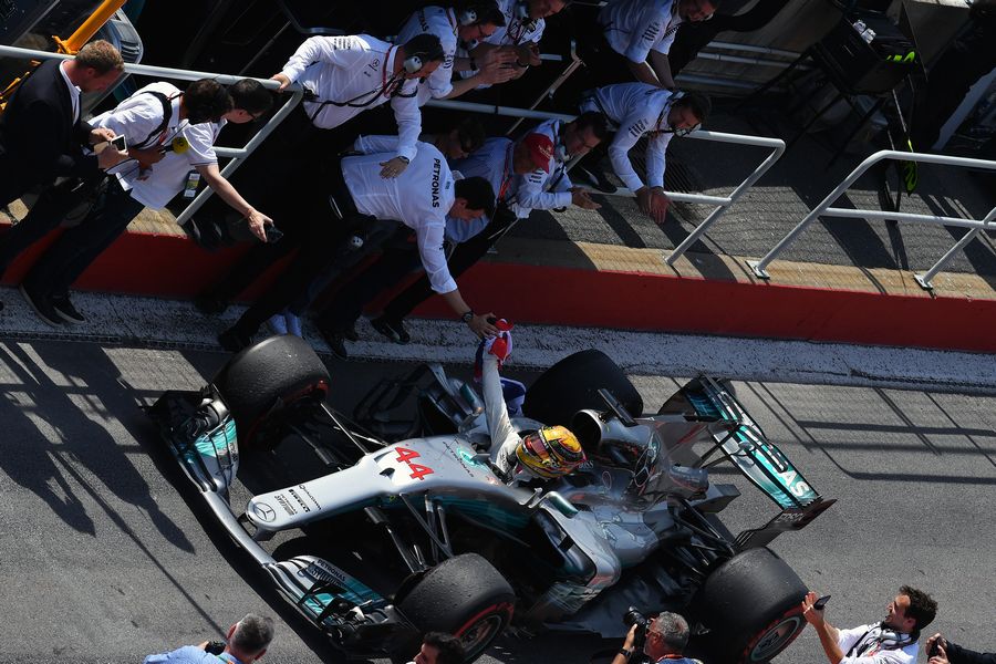 Race winner Lewis Hamilton celebrates with Toto Wolff and arrives in parc ferme