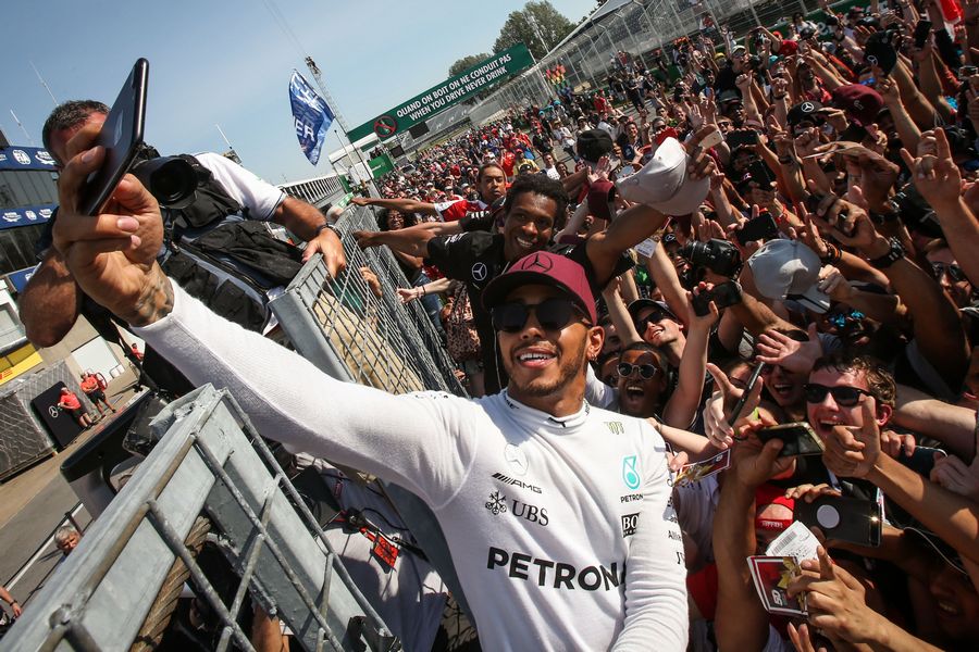 Race winner Lewis Hamilton celebrates with the fans