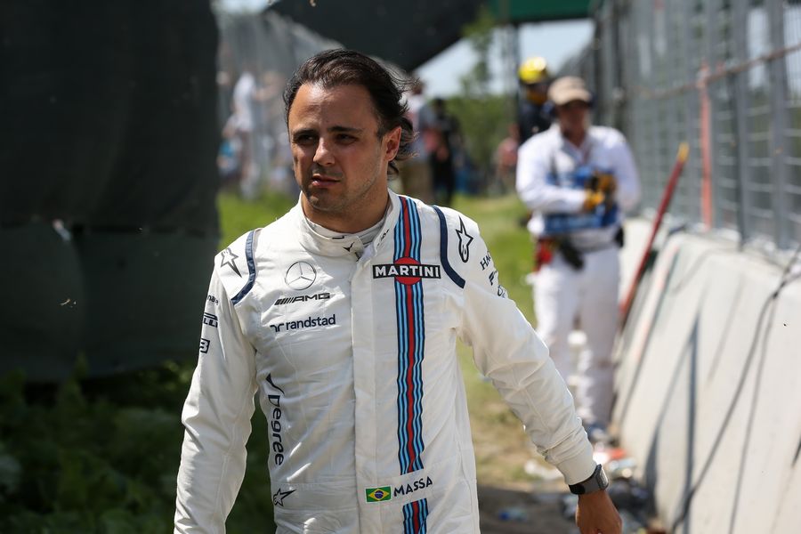 Race retiree Felipe Massa walks back after after crashing out of the race