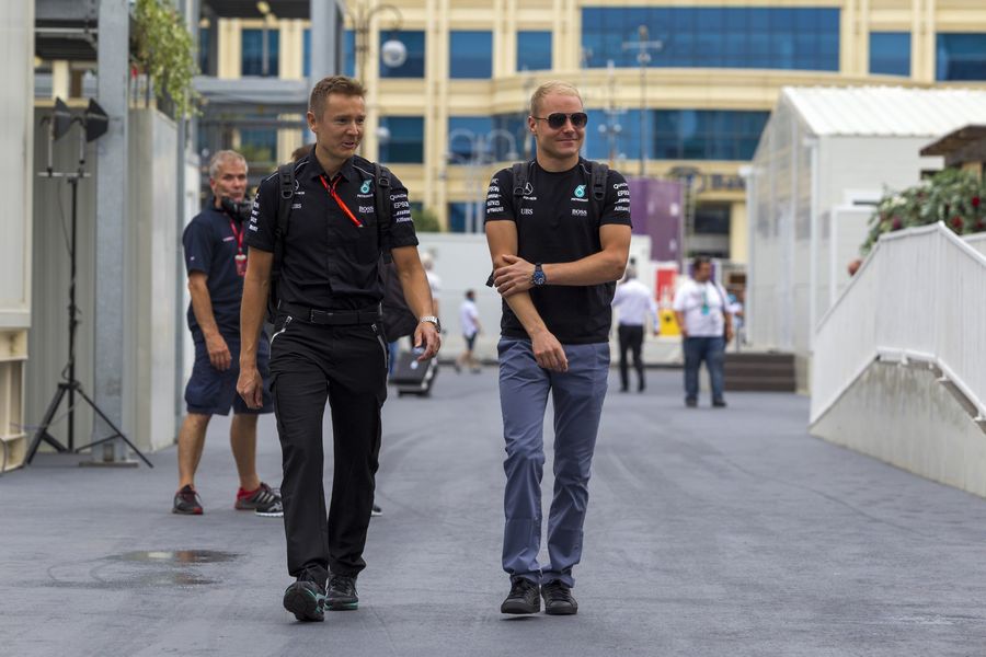Valtteri Bottas walks the paddock with his trainer Antti Vierula