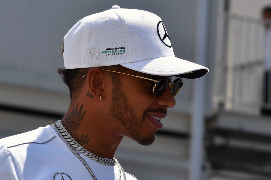 Lewis Hamilton looks relaxed in the paddock