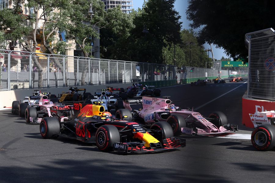 Max Verstappen battles with Sergio Perez for position at the start of the race