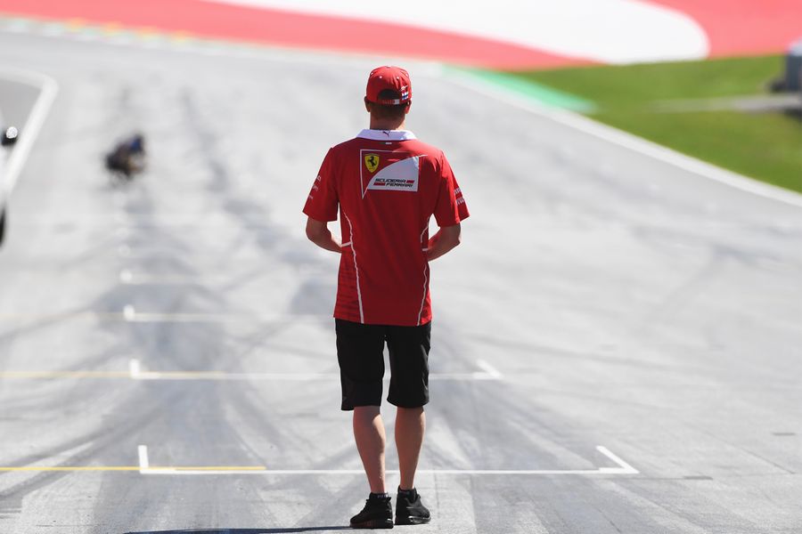 Kimi Raikkonen walks the track