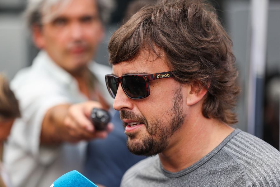 Fernando Alonso talks with the media