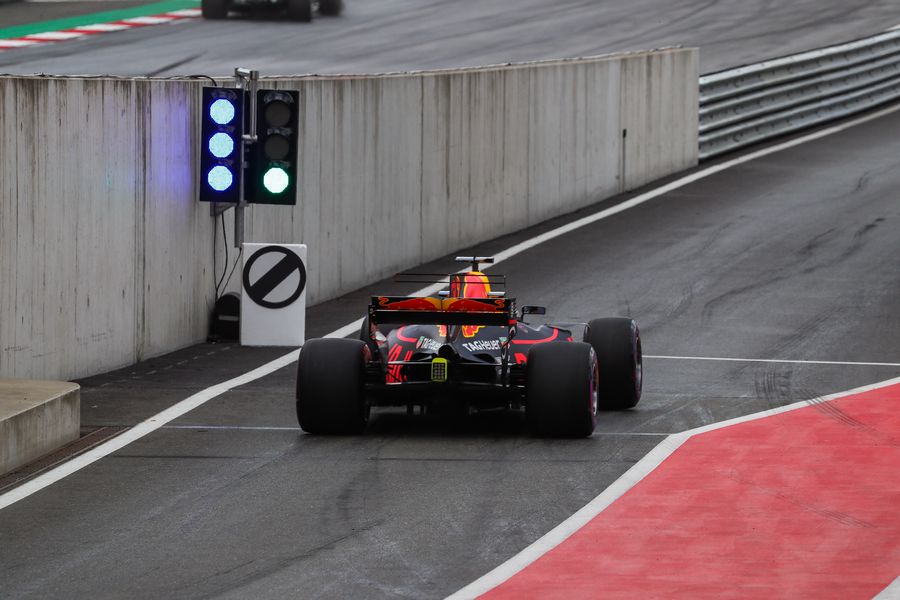 Daniel Ricciardo heads down the pit lane in the Red Bull
