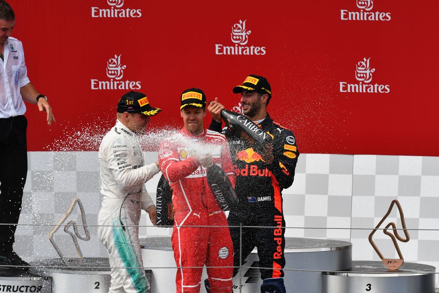 Top 3 drivers celebrates on the podium with the champagne