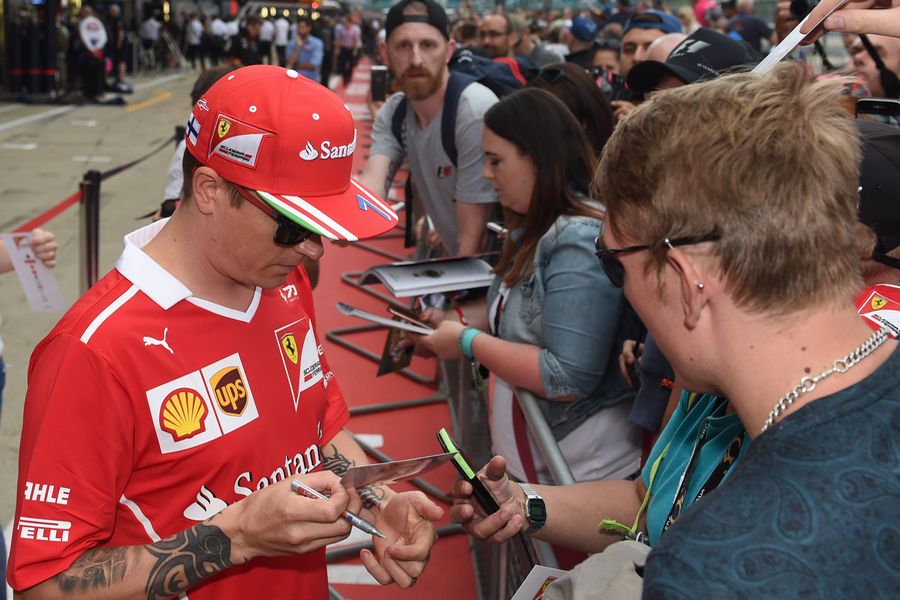Kimi Raikkonen signs autographs for the fans