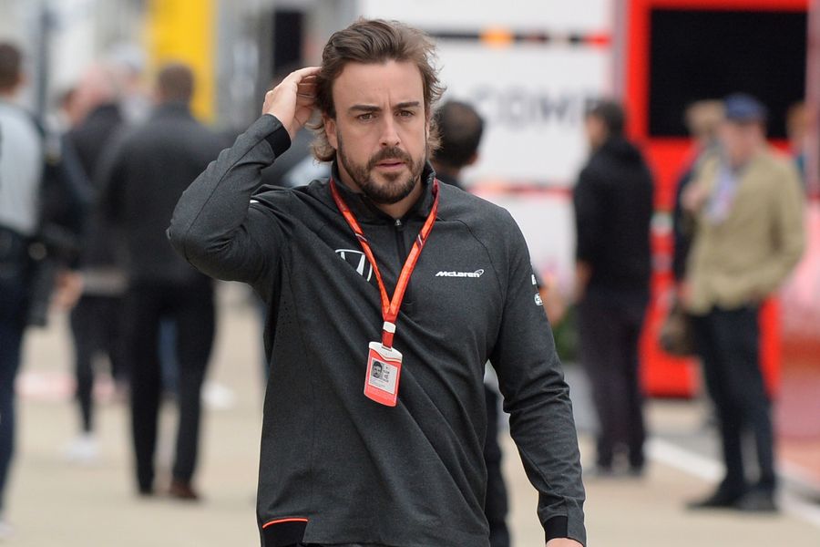 Fernando Alonso walks through the paddock