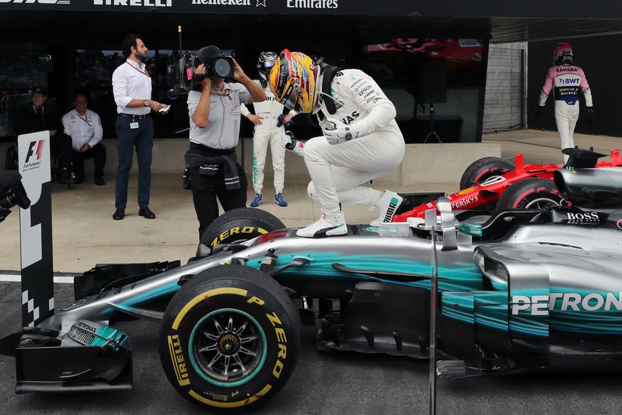 Lewis Hamilton celebrates on the palc ferme