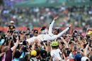 Race winner Lewis Hamilton celebrates with the fans and crowdsurfs