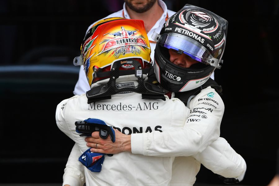Race winner Lewis Hamilton celebrates in parc ferme with Valtteri Bottas