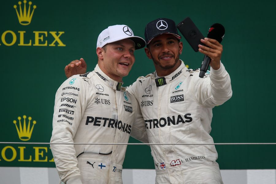 Lewis Hamilton and Valtteri Bottas celebrate on the podium with a selfie