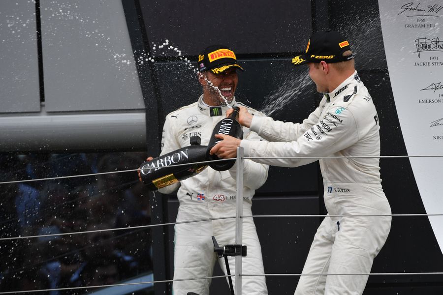 Race winner Lewis Hamilton and Valtteri Bottas celebrates on the podium with the champagne