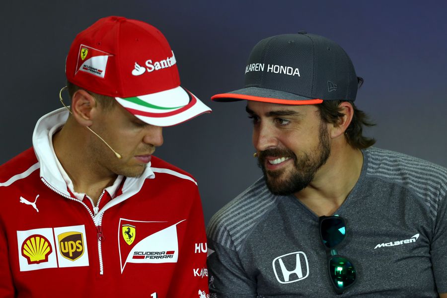 Fernando Alonso talks with Sebastian Vettel in the Press Conference