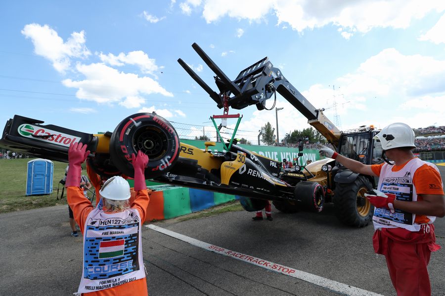The crashed car of Jolyon Palmer is recovered by Marshals in FP2